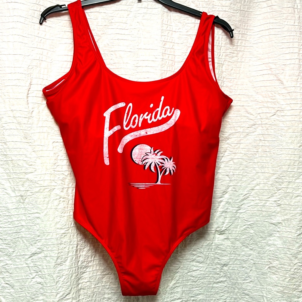 Red one piece with Florida written in white white palm trees outlined in navy